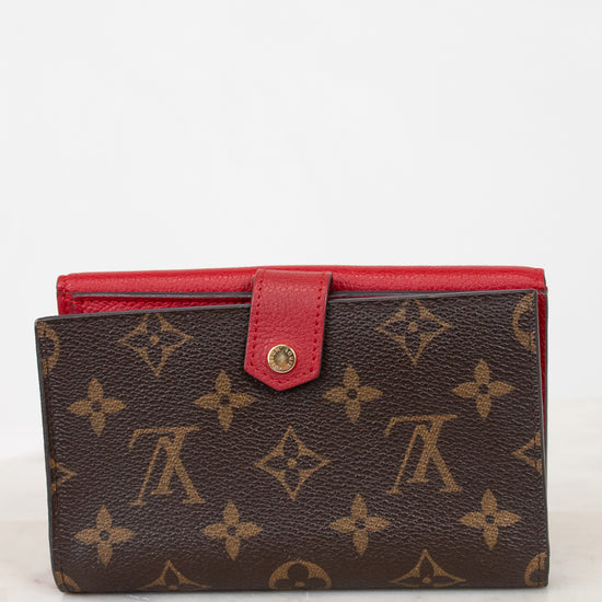 Brown wallet with red interior on a white background