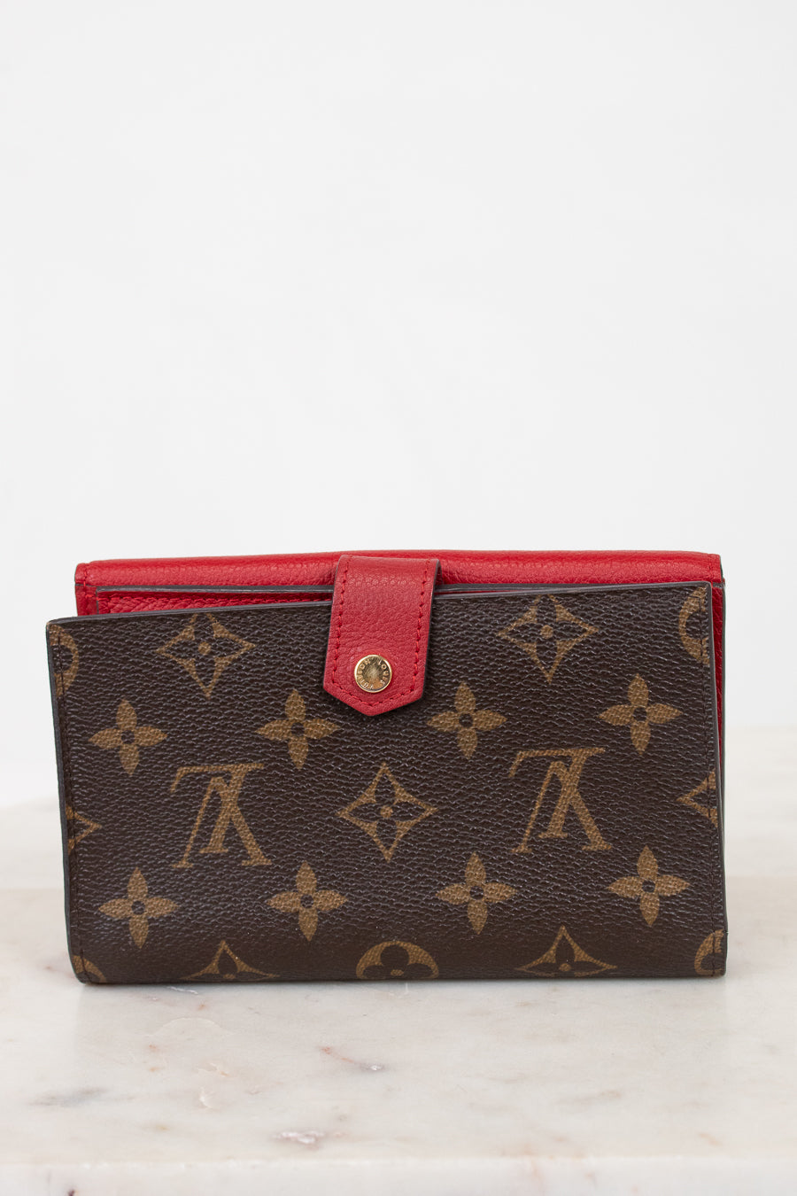 Brown wallet with red interior on a white background