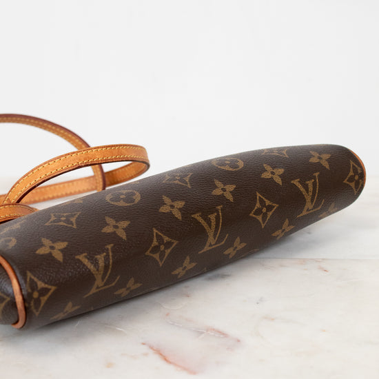 Louis Vuitton monogram clutch on a marble surface
