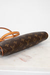 Louis Vuitton monogram clutch on a marble surface