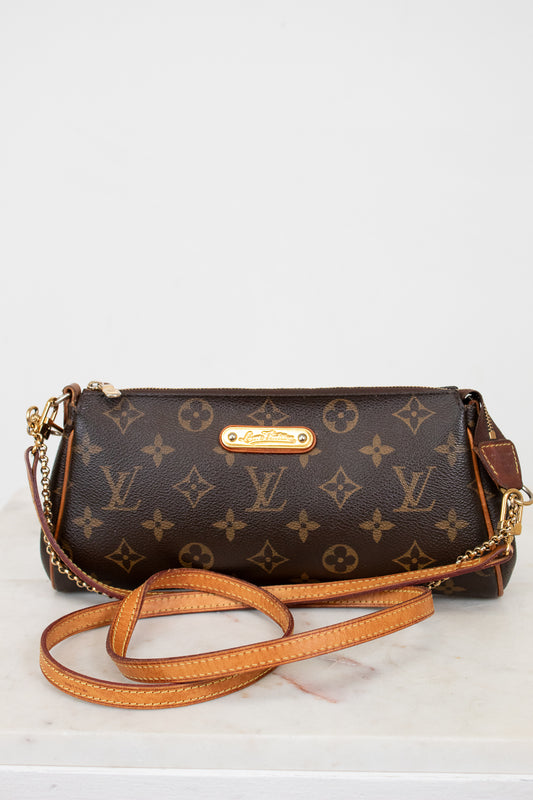 Designer handbag with monogram pattern on a white background