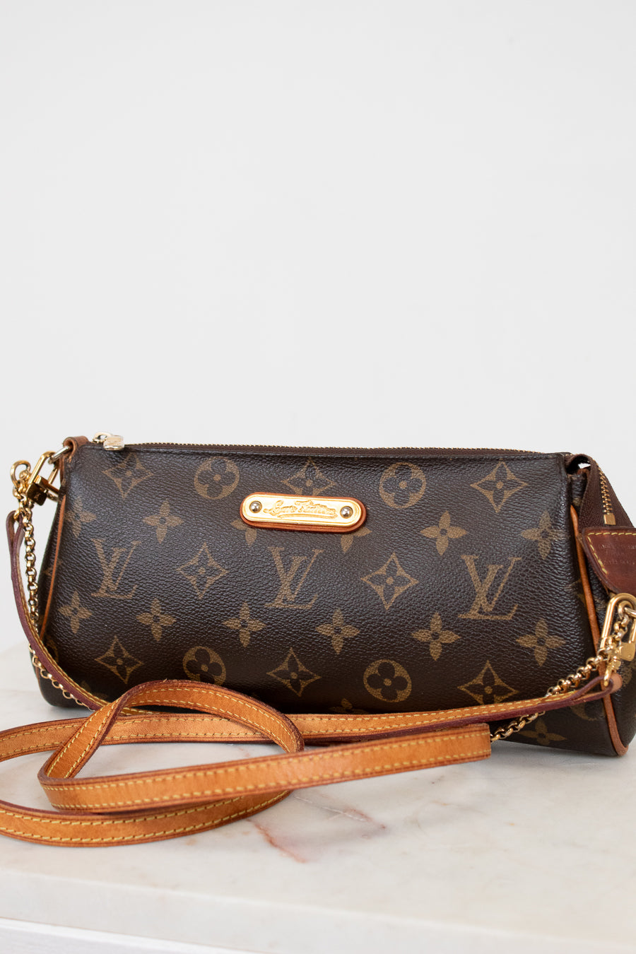 Louis Vuitton handbag with monogram pattern on a white background