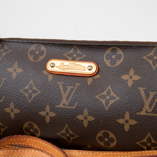 Louis Vuitton handbag with monogram pattern on a light background