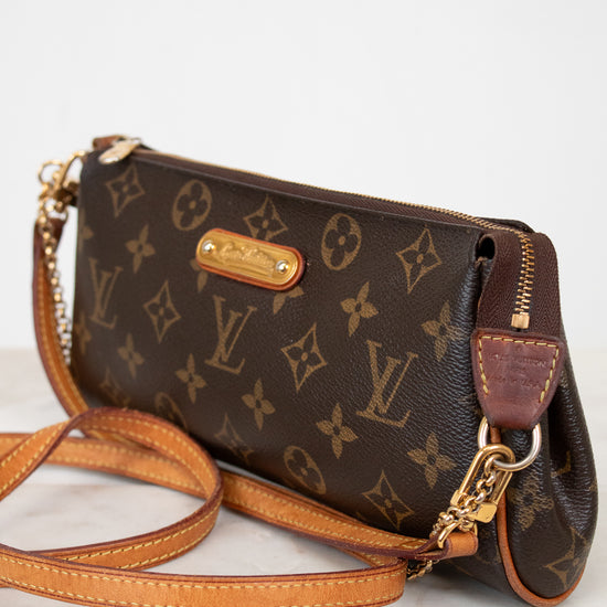 Louis Vuitton monogram handbag with gold hardware on a white background