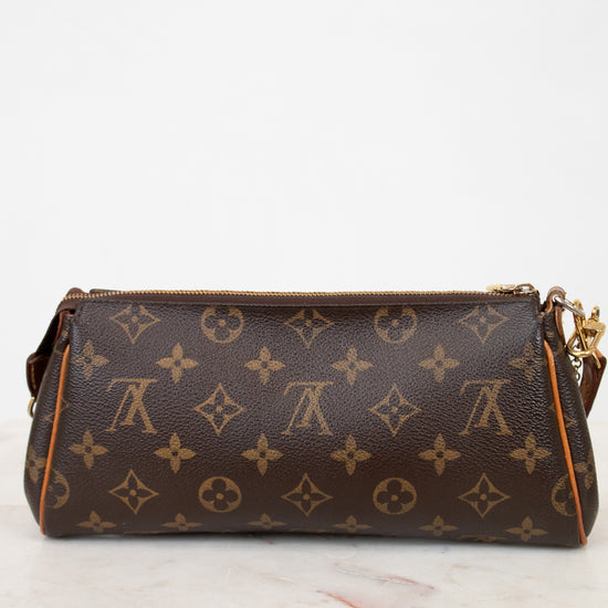 Designer handbag with monogram pattern on a white surface