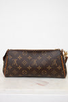Designer handbag with monogram pattern on a white surface