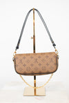 A Louis Vuitton monogram shoulder bag in beige coated canvas with dark brown leather trim and a gold-tone chain strap, displayed on a gold stand against a white background.