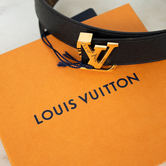 Louis Vuitton belt with gold buckle on an orange Louis Vuitton box