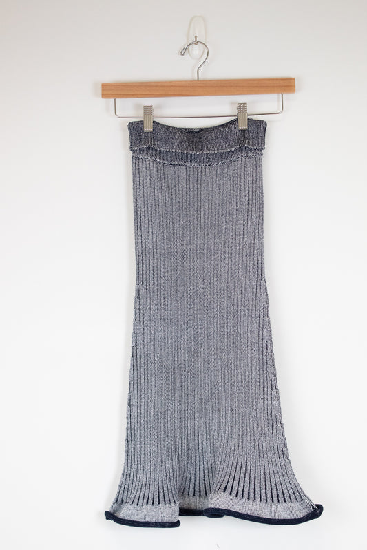 Navy and white ribbed knit skirt on a wooden hanger against a white background