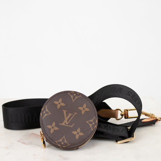 Louis Vuitton monogram handbag with black strap on a white background