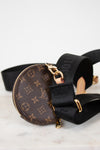 Louis Vuitton monogram bag with black strap on a light background