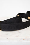 Black Louis Vuitton strap on a marble surface