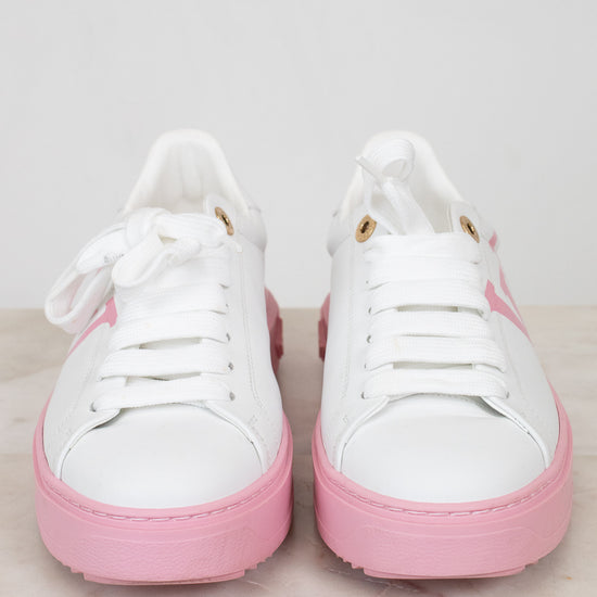 White sneakers with pink soles on a light gray background