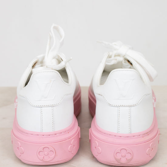 White sneakers with pink soles on a light background