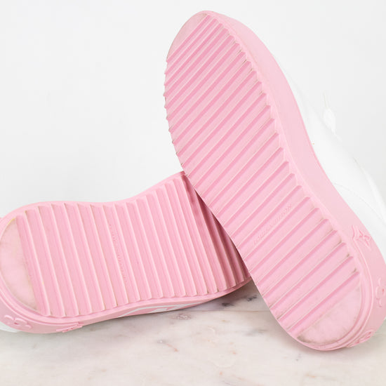 Pink soles of sneakers on a marble surface