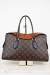 Louis Vuitton handbag with monogram pattern on a white background
