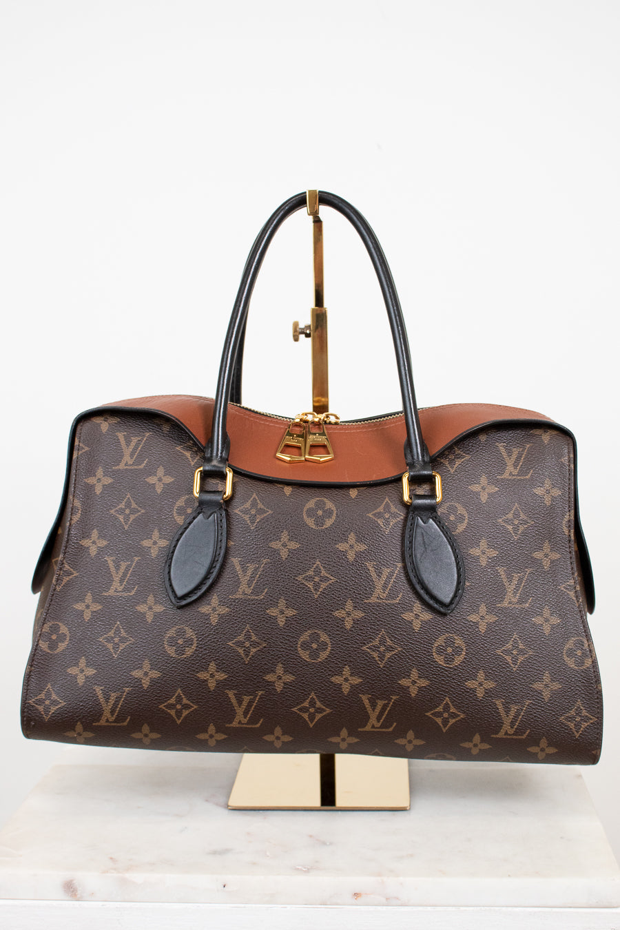 Louis Vuitton handbag with monogram pattern on a white background