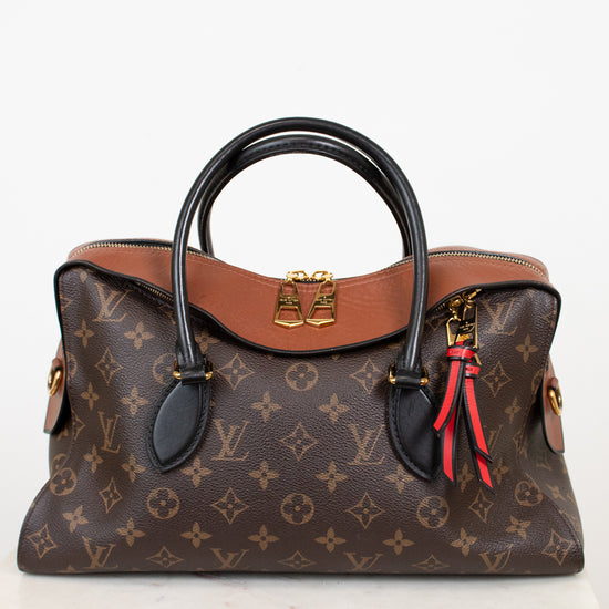 Designer handbag with monogram pattern on a white background