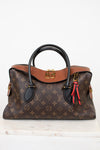 Designer handbag with monogram pattern on a white background