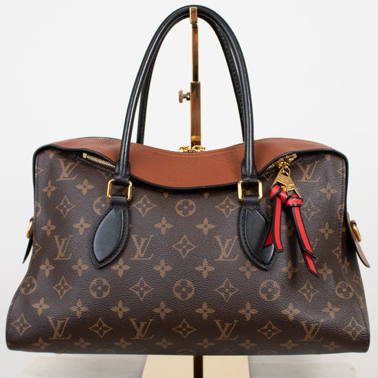 Designer handbag with monogram pattern on a white background