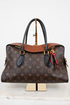 Designer handbag with monogram pattern on a white background