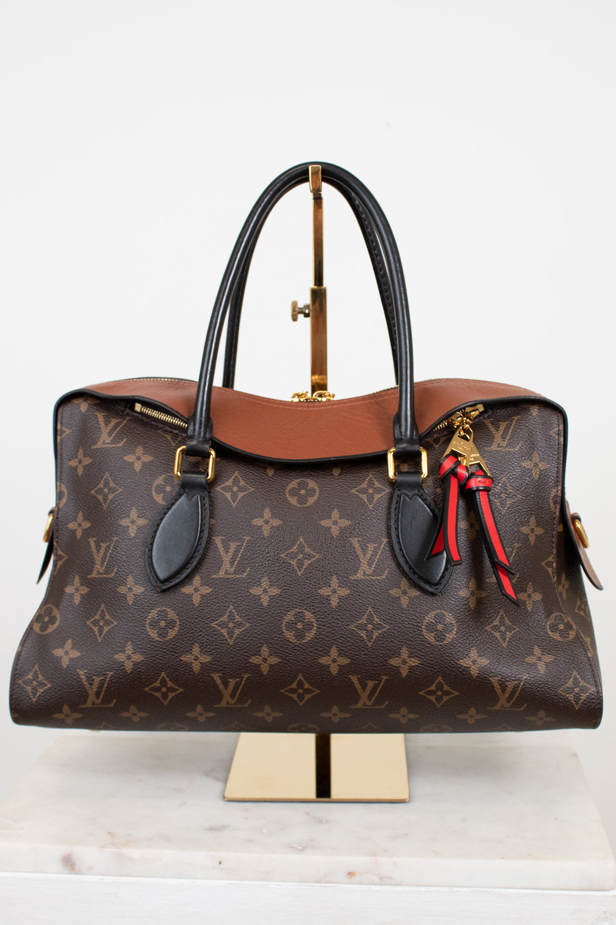 Designer handbag with monogram pattern on a white background