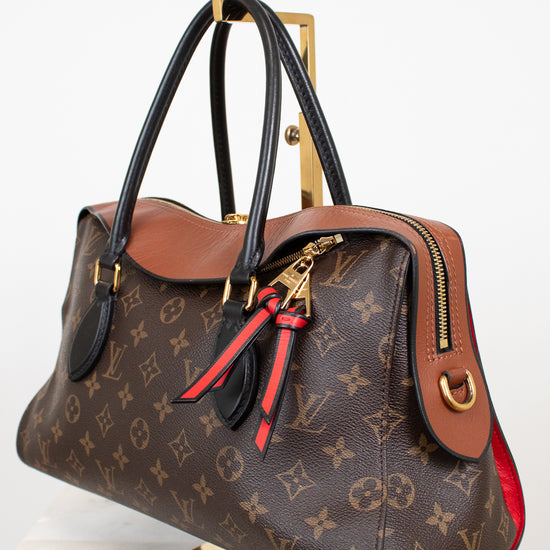 Designer handbag with monogram pattern on a white background