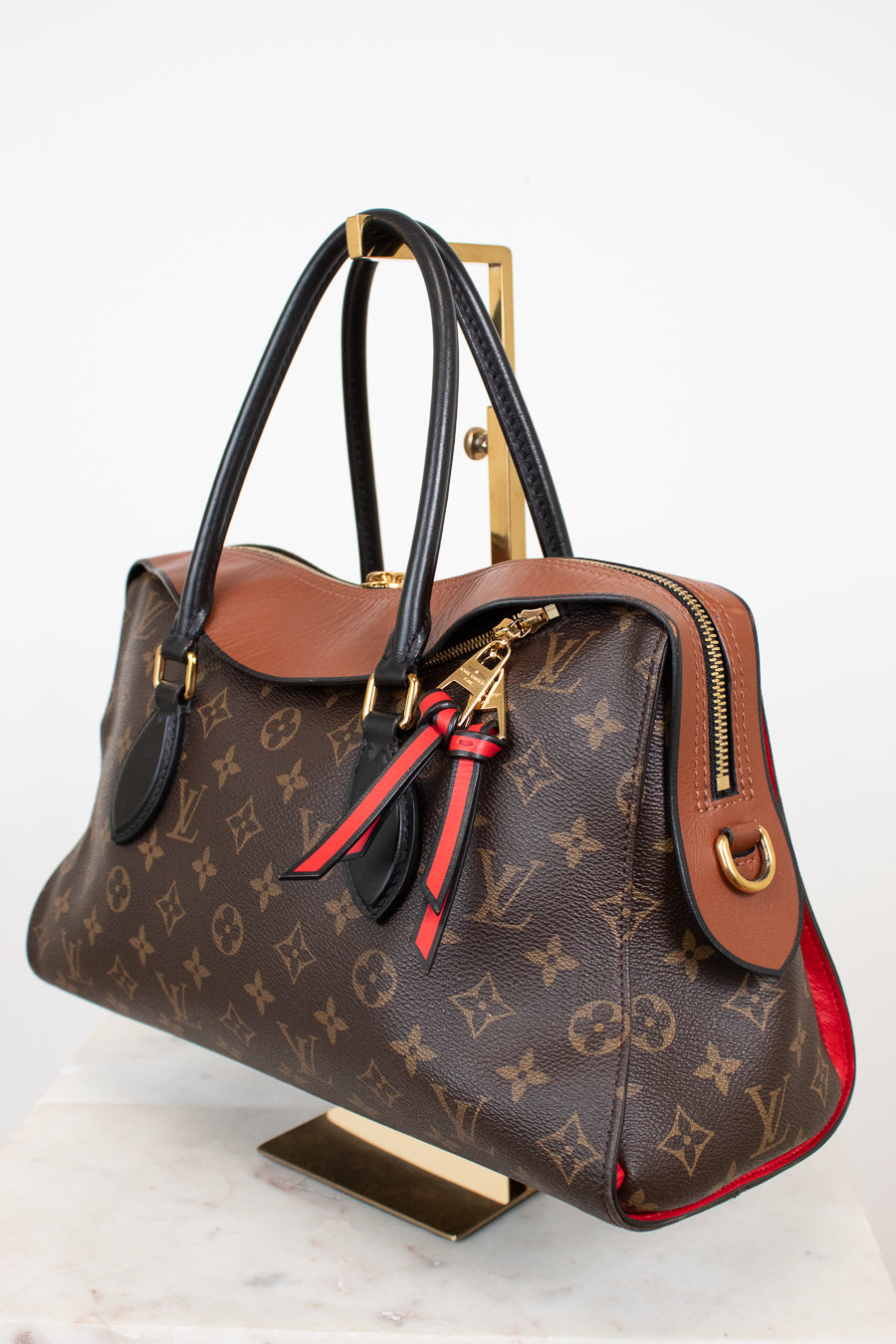 Designer handbag with monogram pattern on a white background