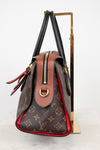 Designer handbag with monogram pattern on a white background