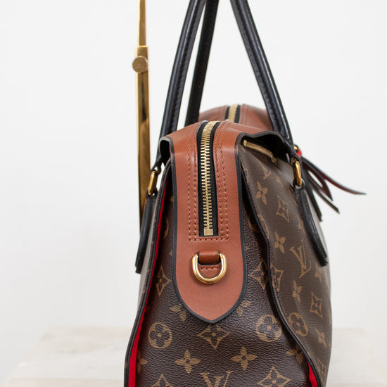 Designer handbag with monogram pattern on a white background