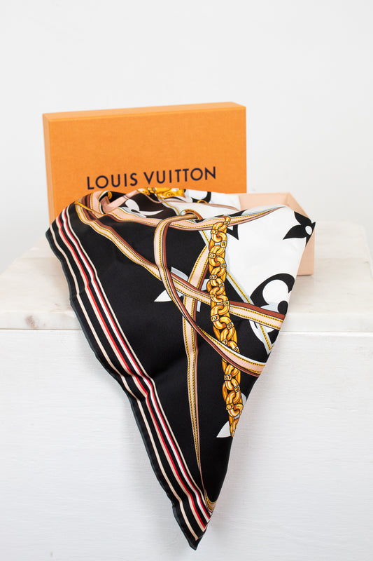 Louis Vuitton scarf with decorative chain print folded with orange box on a white background