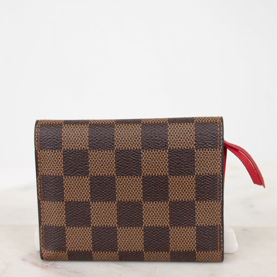 Back of checkered wallet with a red pull on a light background