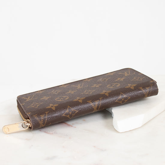 Brown patterned wallet on a white surface