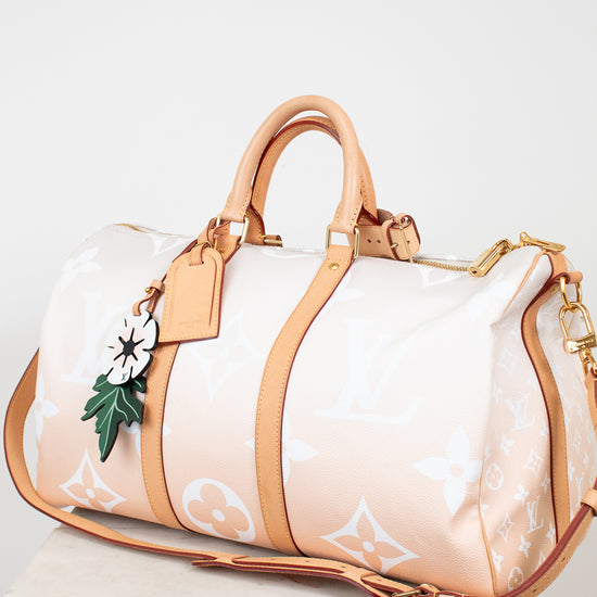 Designer handbag with beige strap and white body on a light background