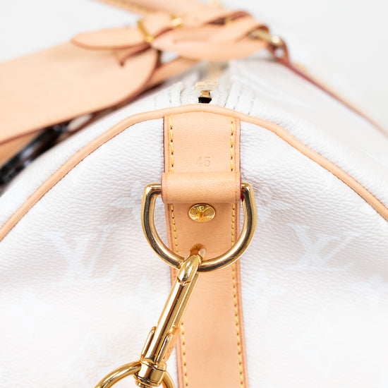 Close-up of a beige handbag with gold hardware on a white background