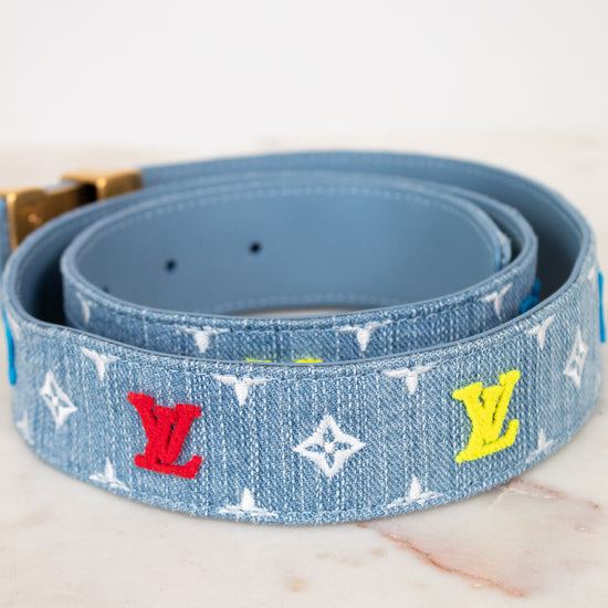 Blue belt with colorful monogram pattern on a white background