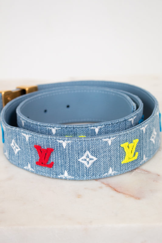 Blue belt with colorful monogram pattern on a white background