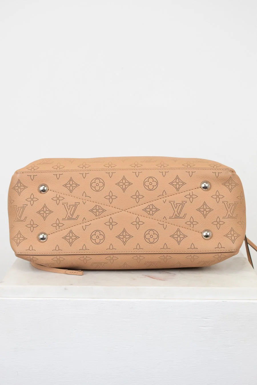 Beige handbag with brand logo on a white background