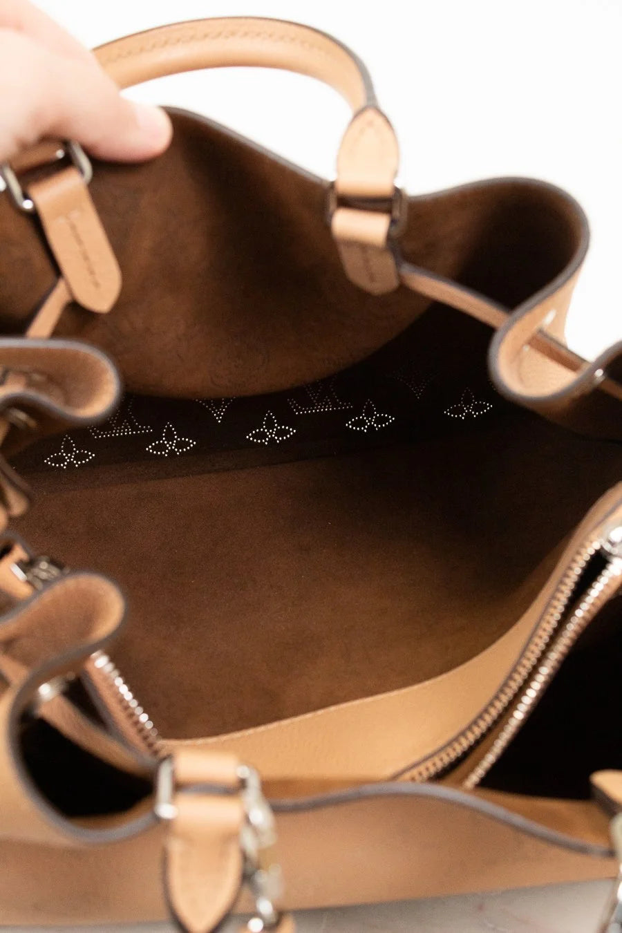 Brown leather handbag with visible brand logo on a white background
