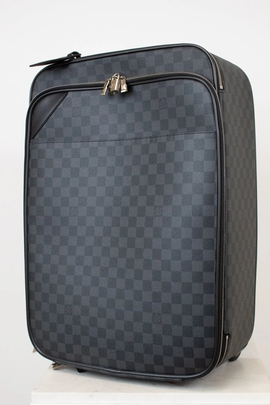 Checkered patterned suitcase on a white background