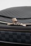 Close-up of a black checkered bag with a silver zipper