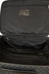 Black suitcase with a brand label on a black background