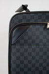 Black checkered suitcase with a silver zipper on a light gray background