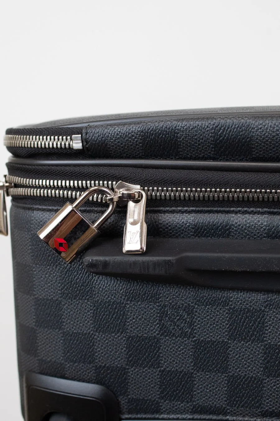 Black checkered suitcase with a silver lock on a white background