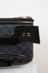Black checkered bag with a visible brand tag on a white background