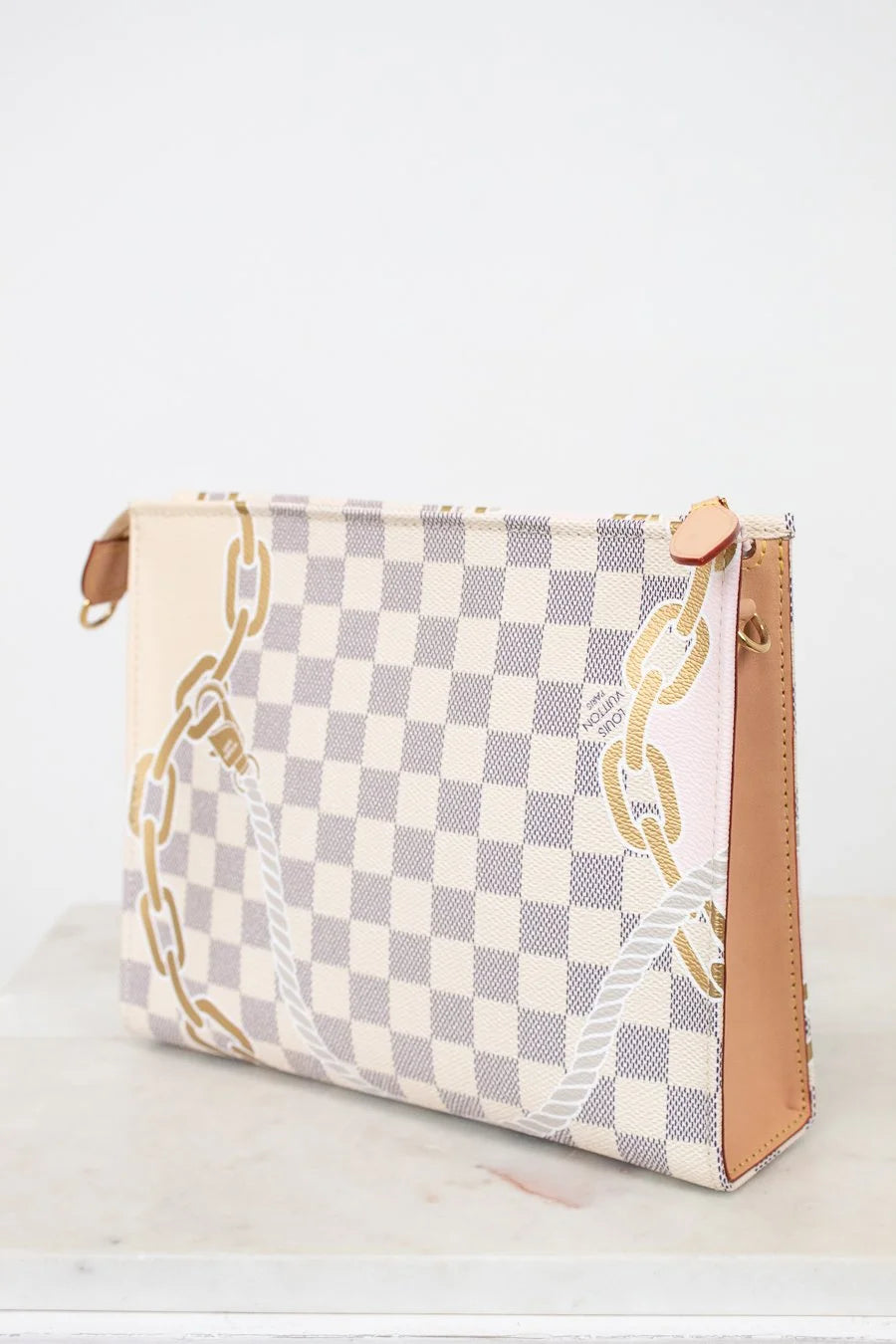 Checkered pouch with gold chain design on a white background