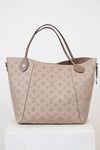 Beige handbag with monogram pattern on a white background