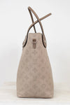 Beige handbag with monogram pattern on a white background