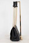 Black handbag with gold chain strap on a white background