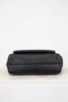 Black handbag with a pattern on a white background